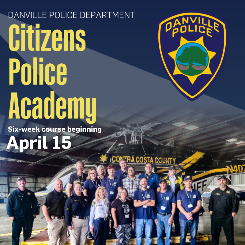 Citizens Police Academy with residents and officers standing next to police helicopter